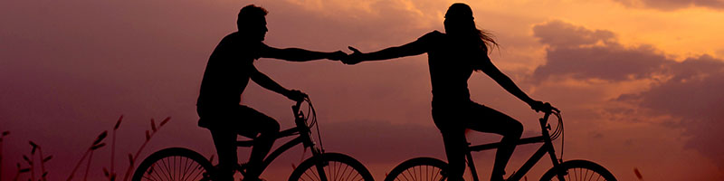 People biking and holding hands